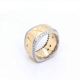 Yellow gold with a hint of white gold diamond ring featuring diamonds. The band is adorned with an engraved letter. The object is set on white background.